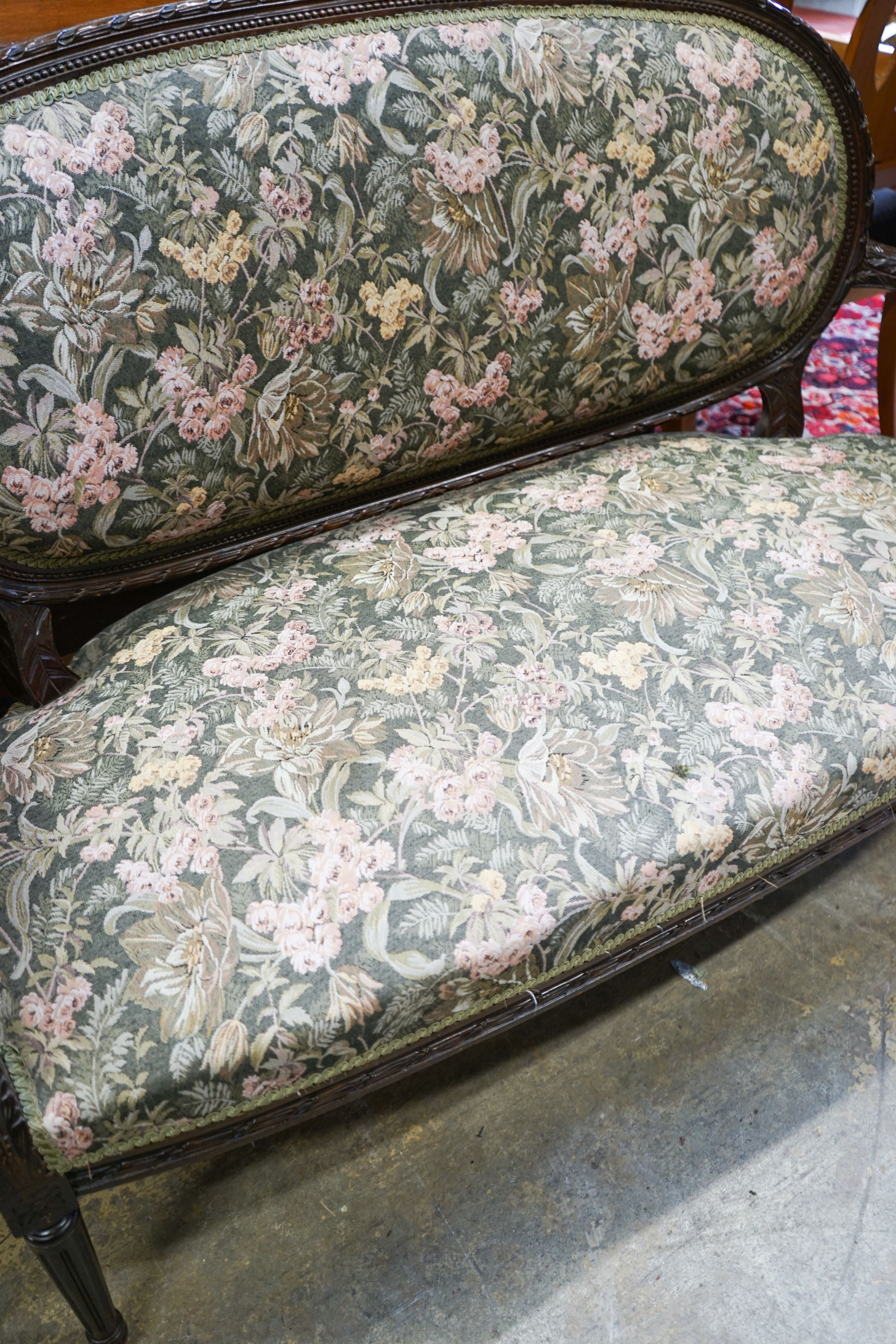 An early 20th century French carved frame upholstered canape, length 132cm, depth 52cm, height 94cm